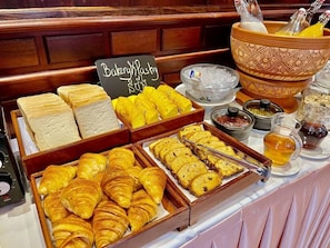 A bakery display with various pastries and bread, a sign reading 'Bakery Pastry,' and condiments. - Okay 1 Villa (Siem Reap)