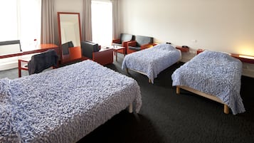 Two single beds, a desk, sofa, and flat-screen TV make this room a comfortable retreat.