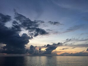 A sunset over a calm sea with clouds. - Tuscany Resort (Hengchun)