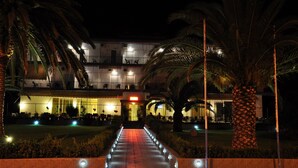 A hotel entrance at night with a well-lit pathway leading to the building. - Elena Hotel (Lokroi)