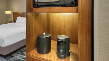 A compact kitchenette with a microwave, a coffee maker, and a refrigerator.