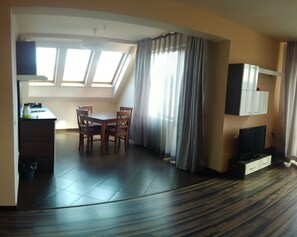 A compact living space with a kitchenette, a dining area, and a TV. - City Hotel Blagoevgrad (Blagoevgrad)