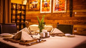 A dining table set with a vase, salt and pepper shakers, and a placemat. - Zawadi House (Arusha)
