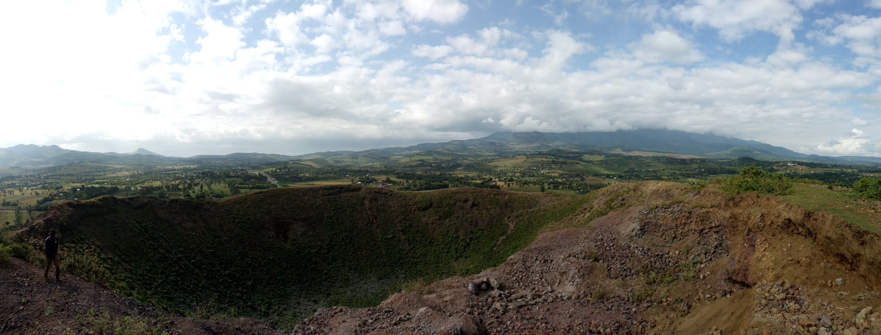 A panoramic view of a mountainous landscape with a clear sky.