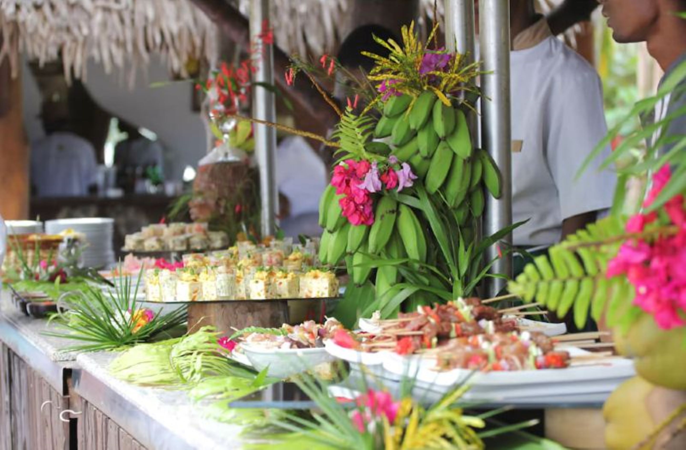 A buffet with various dishes and a decorative centerpiece.