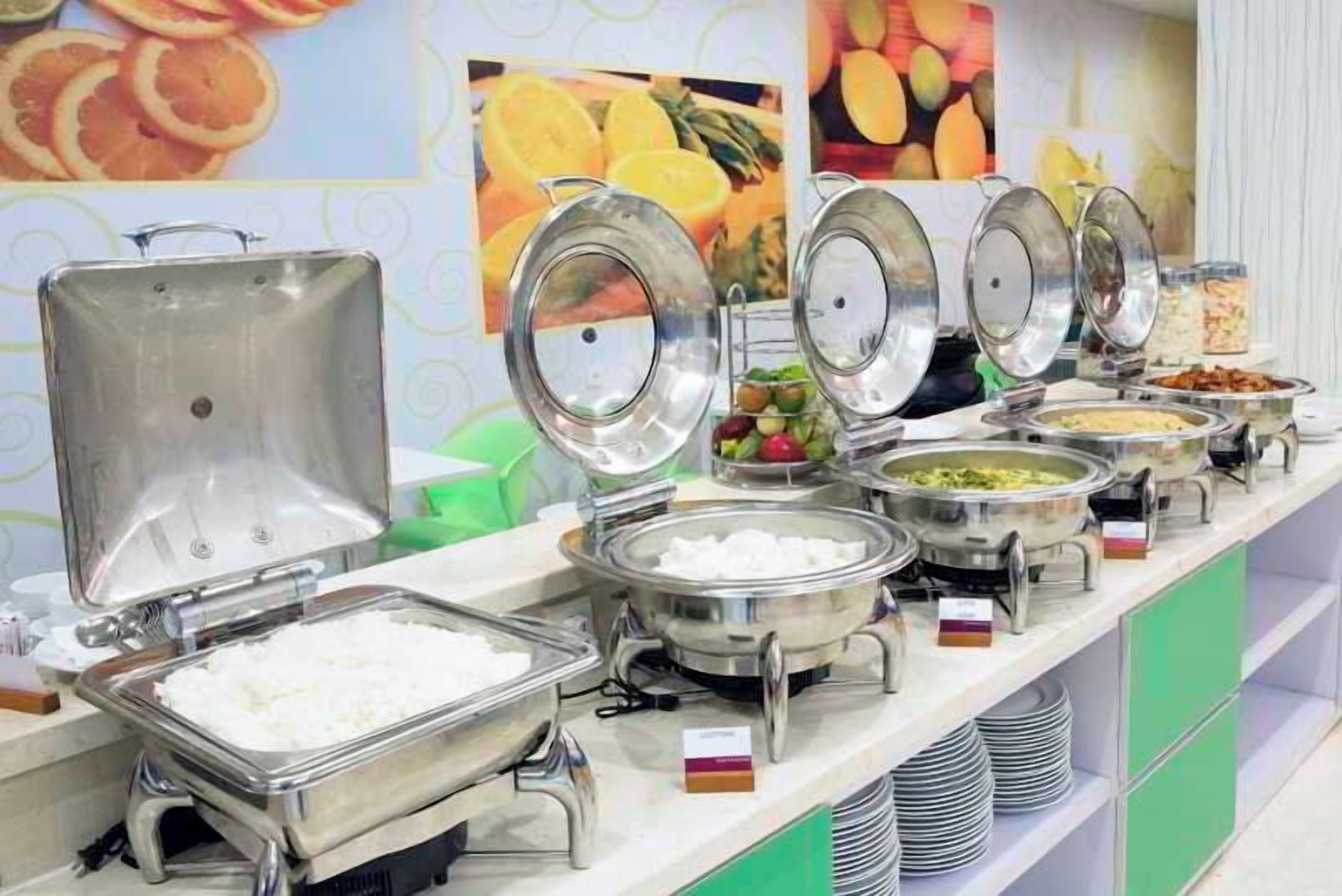 A buffet with various food items and a salad bar.