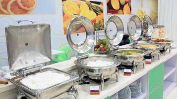 A buffet with various food items and a salad bar.