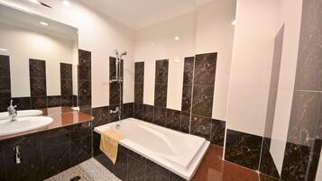 Combined shower/bathtub, designer toiletries, hair dryer, bathrobes