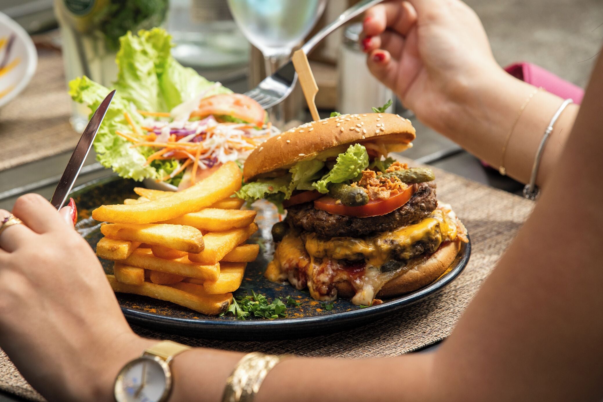 A meal consisting of a burger and fries on a plate.