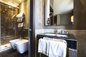 A modern bathroom with a glass-enclosed shower, a double sink vanity, and a large mirror.