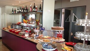 Una barra de buffet con diversos alimentos y bebidas.