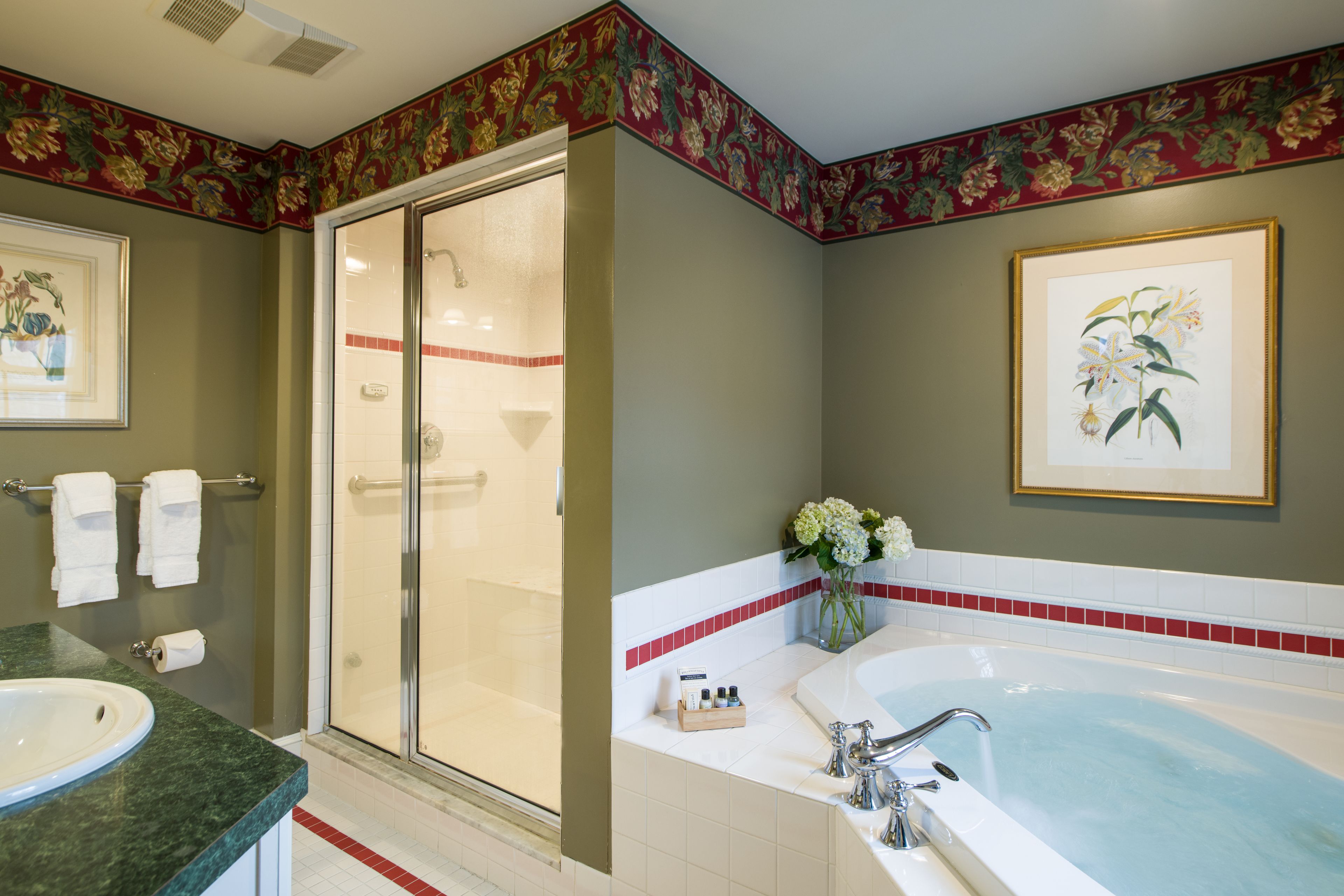A bathroom with a shower, bathtub, and sink.