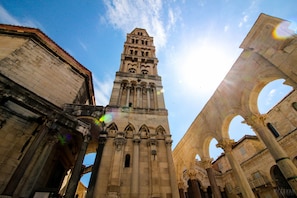 A historic building with a prominent tower and arches.