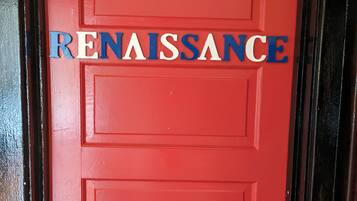 A red door with the word "RENAISSANCE" in blue and white letters.