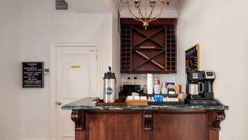 A bar area with a coffee machine, a sign indicating a restroom, and a chalkboard menu.