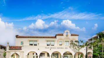 Experience the charm of a classic Mediterranean-style inn with an arched entrance and tiled roof.