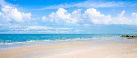 A beach with clear skies and calm waters.