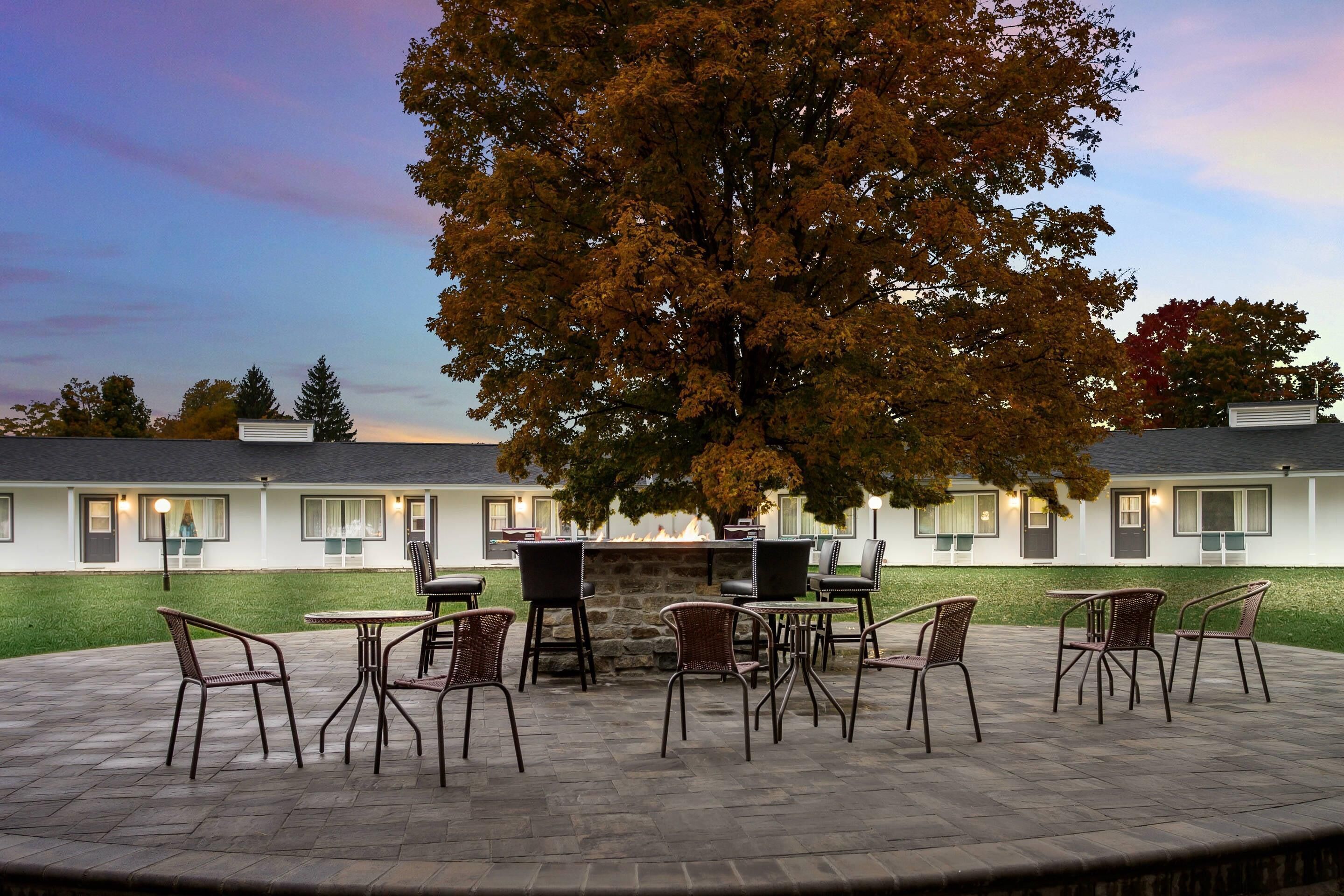 A patio area with outdoor seating and a stone fireplace.