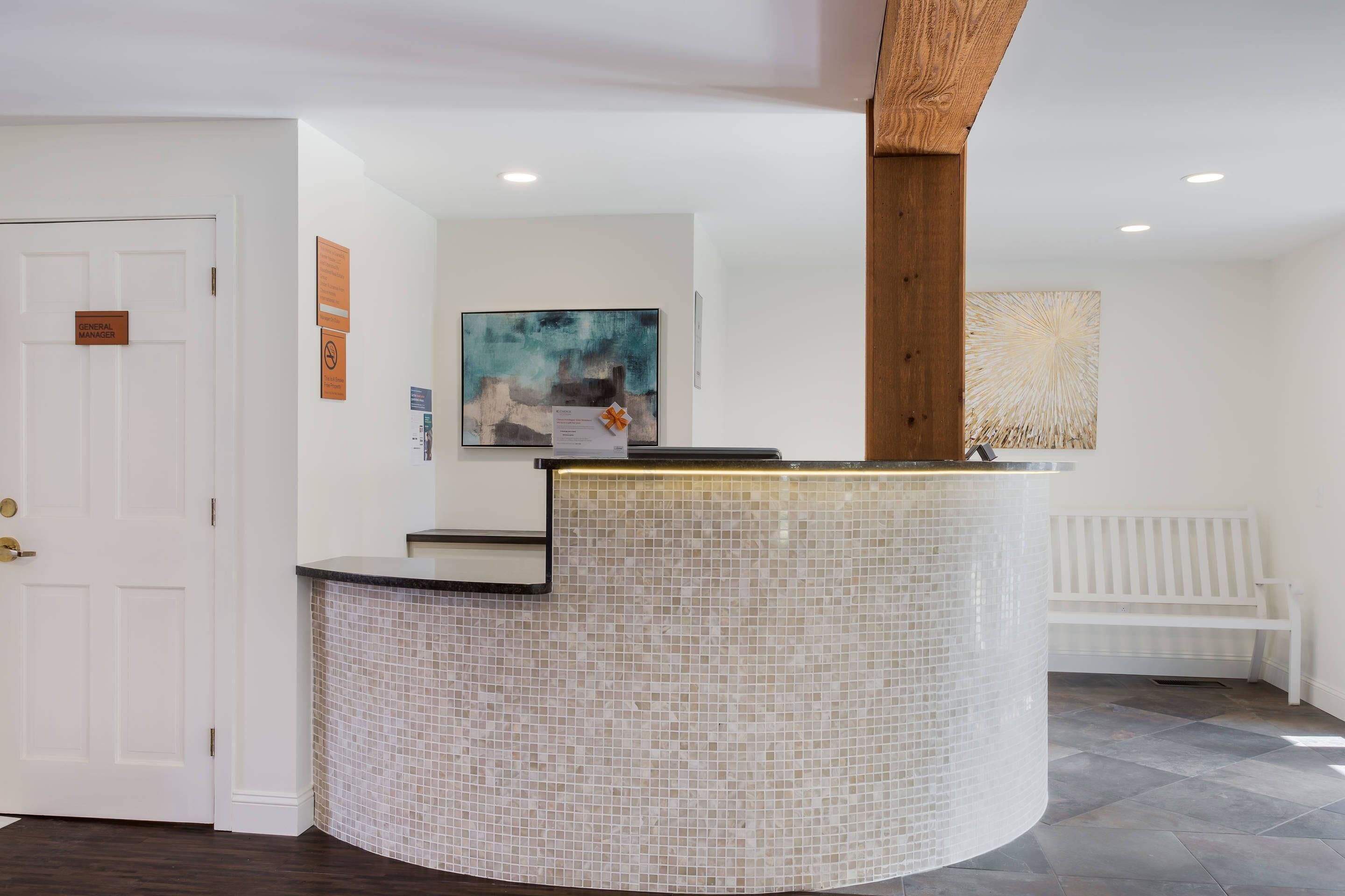 A reception area with a tiled counter, a white bench, and a door labeled "General Lobby".