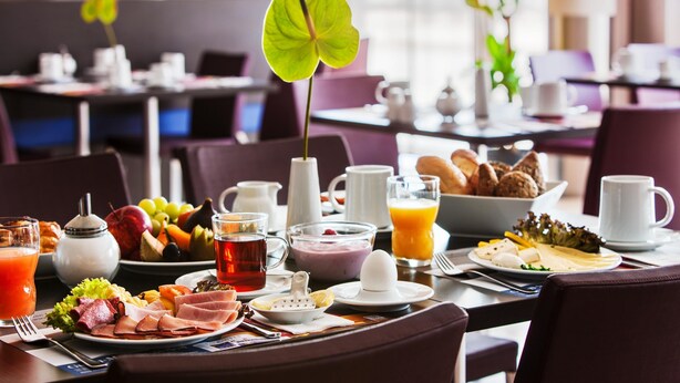 A breakfast setting with a variety of food items, including fruits, pastries, and beverages. - IntercityHotel Berlin Hauptbahnhof (Berlin)