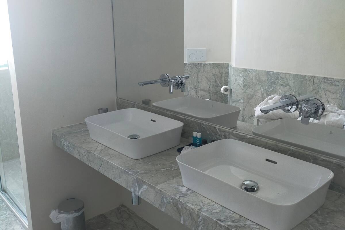 deluxe suite | bathroom | shower, rainfall showerhead, free toiletries, hair dryer