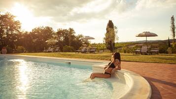 Seasonal outdoor pool, open 7:30 AM to 8:00 PM, pool umbrellas