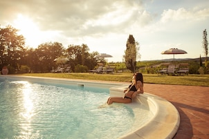 Seasonal outdoor pool, open 7:30 AM to 8:00 PM, pool umbrellas