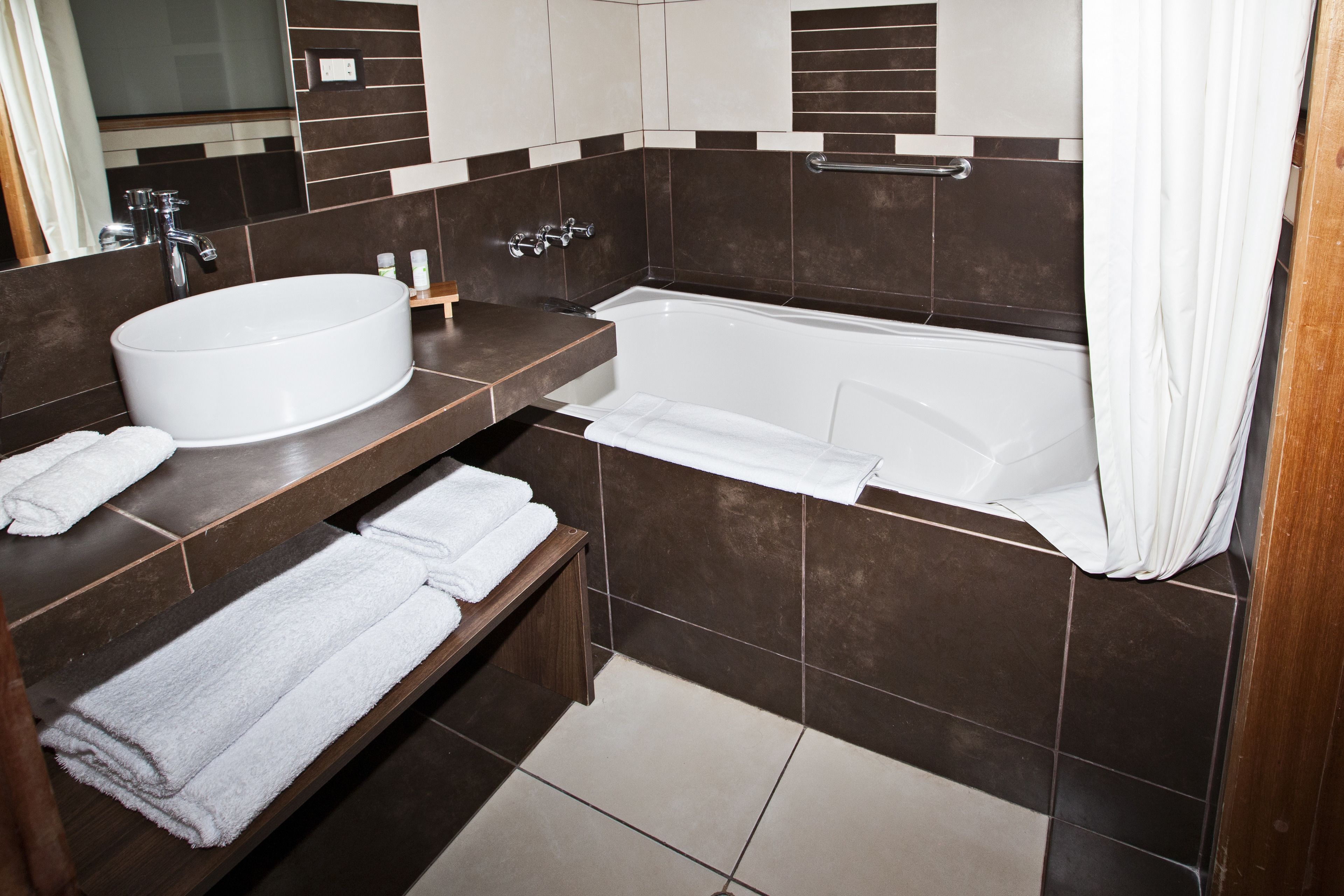 combined shower/bathtub, rainfall showerhead, designer toiletries