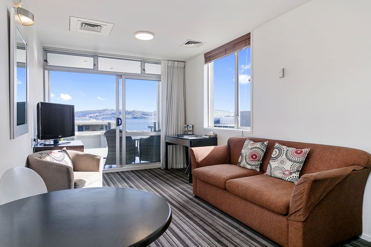 Apartment, 1 Bedroom, Lake View | Living area | Flat-screen TV