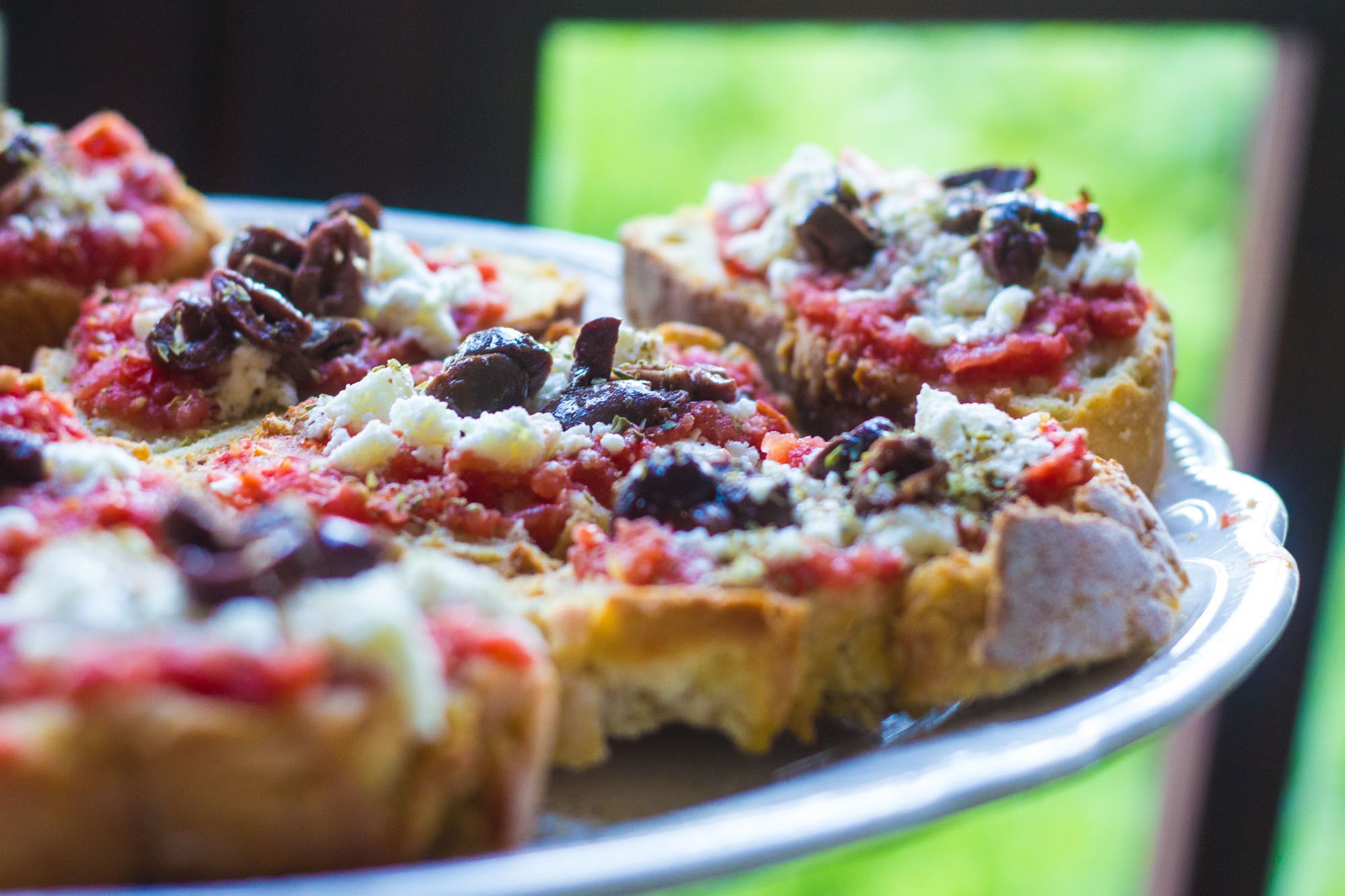 A close-up of a pizza with various toppings on a plate.