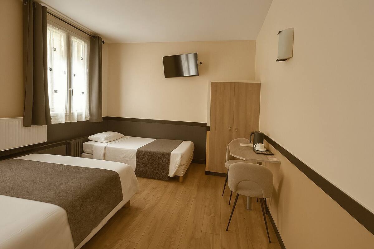 A hotel room with two beds, a desk, a chair, a wardrobe, and a TV on the wall.