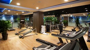 A gym with treadmills, stationary bikes, and weight machines.