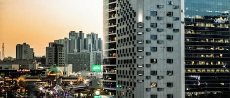 A modern hotel with a distinctive facade, multiple floors, and a prominent sign.