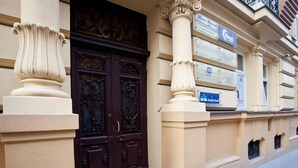 A building facade with ornate double doors, a sign for 'Moon Hostel', and a 'Kreditbank' sign. - Moon Hostel Warszawa (Warsaw)