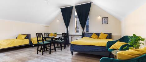 Una habitación con cama tipo literas, un escritorio y dos sillas.