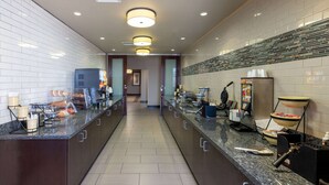 A modern kitchen with granite countertops, a coffee machine, and a waffle maker. - La Quinta Inn & Suites by Wyndham Durant (Durant)