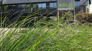 A building with a 'Sole' sign, indicating a vacant property. - Solé Beach (Montauk)