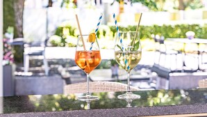 Two drinks on a table with a blurred outdoor background. - Hotel Schützen (Rheinfelden)