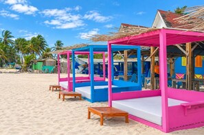 A beachside structure with a roof and seating area.