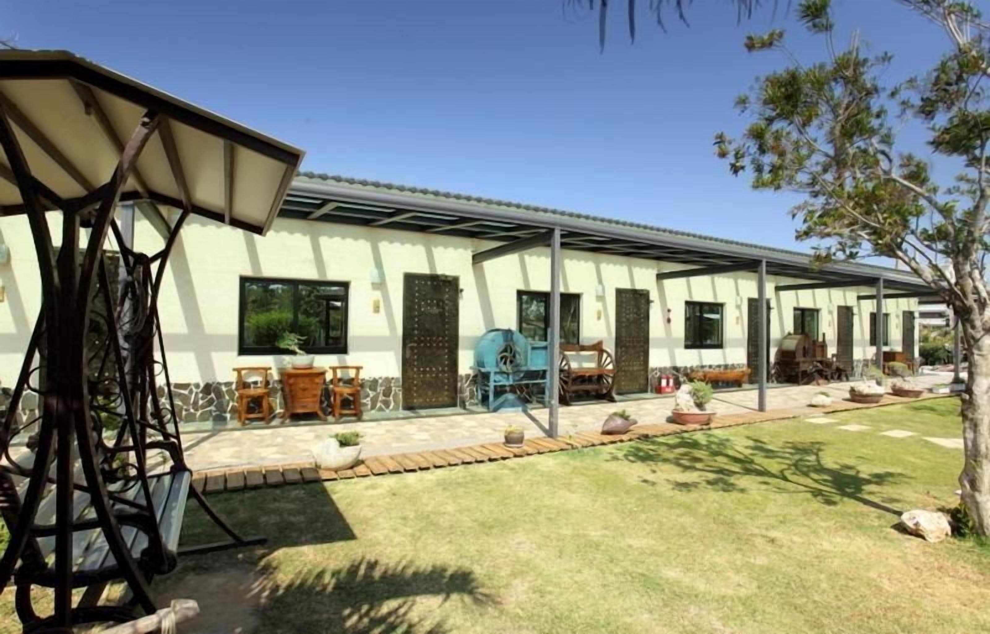 A covered patio area with outdoor furniture and a pergola structure.