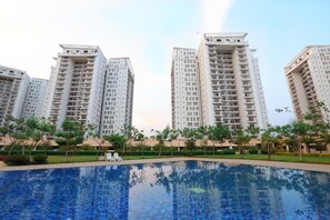 A residential building complex with a swimming pool. - Crest Executive Suites (Bengaluru)
