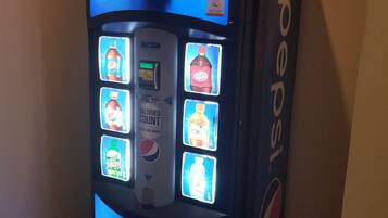 A Pepsi vending machine with a digital display and a calorie counter.