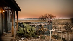 A wooden building with a sign reading "DRAGOON MOUNTAIN VIEWS". - Tombstone Monument Guest Ranch (Tombstone)