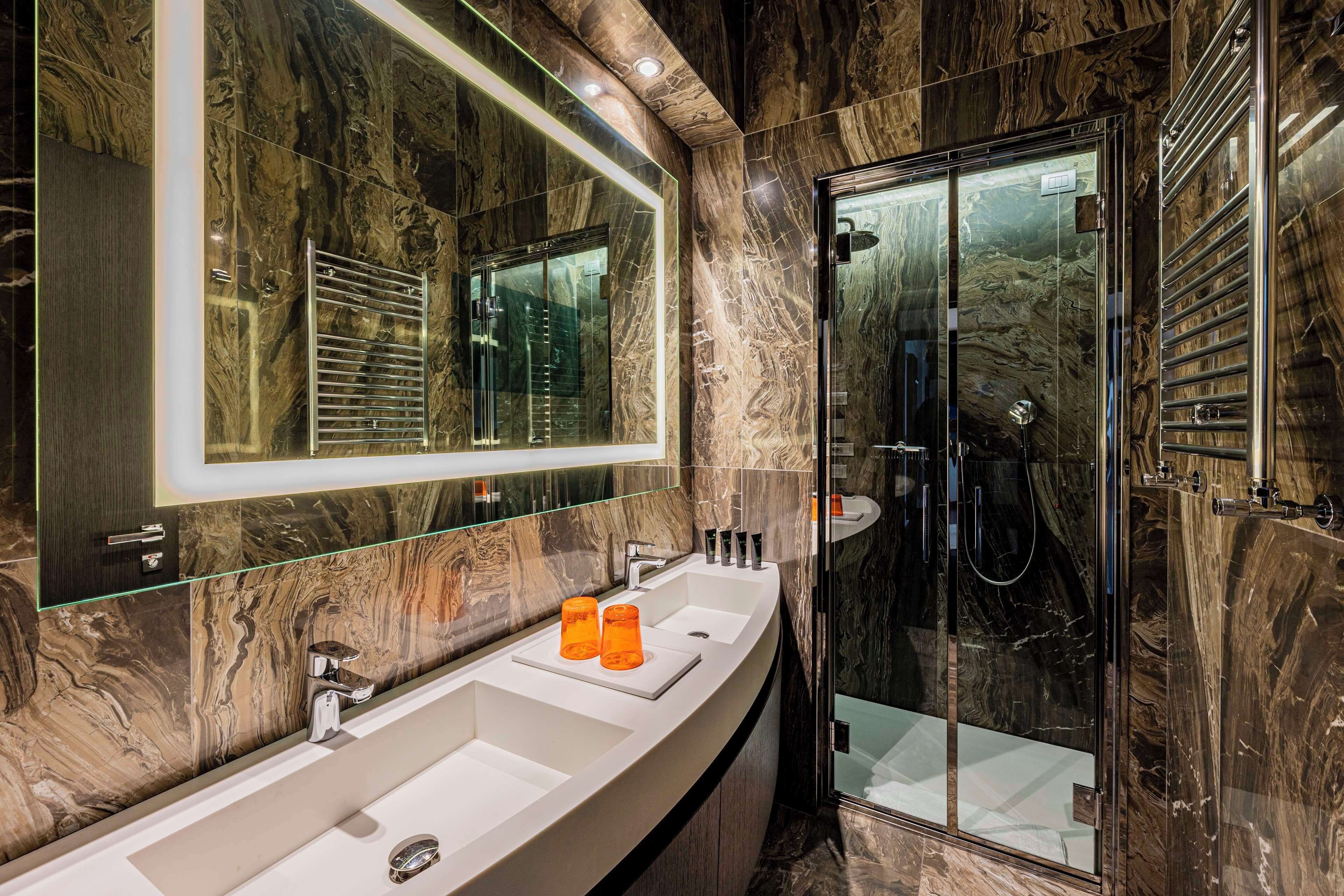 suite (riva, canal view) | bathroom | rainfall showerhead, free toiletries, hair dryer, slippers