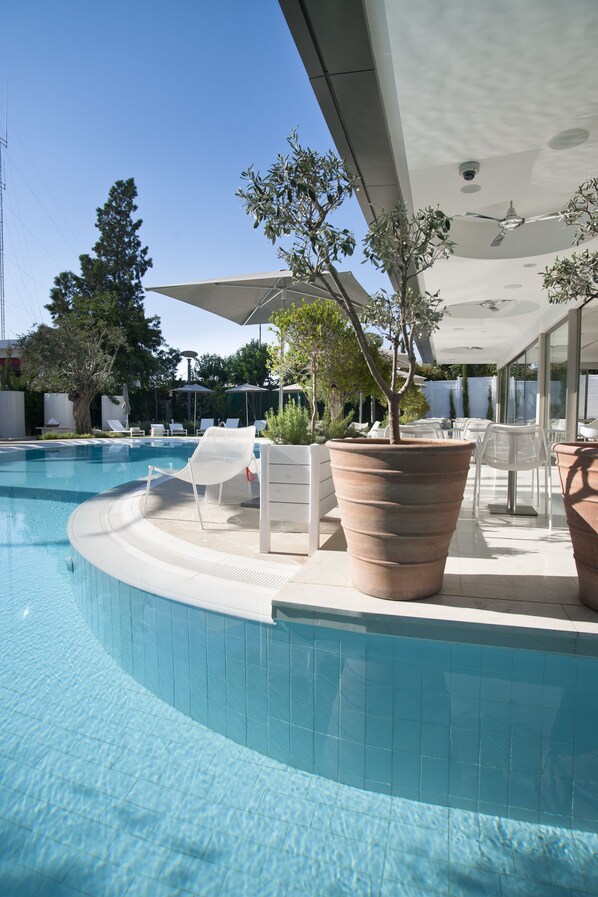 Indoor pool, outdoor pool, pool umbrellas, pool loungers