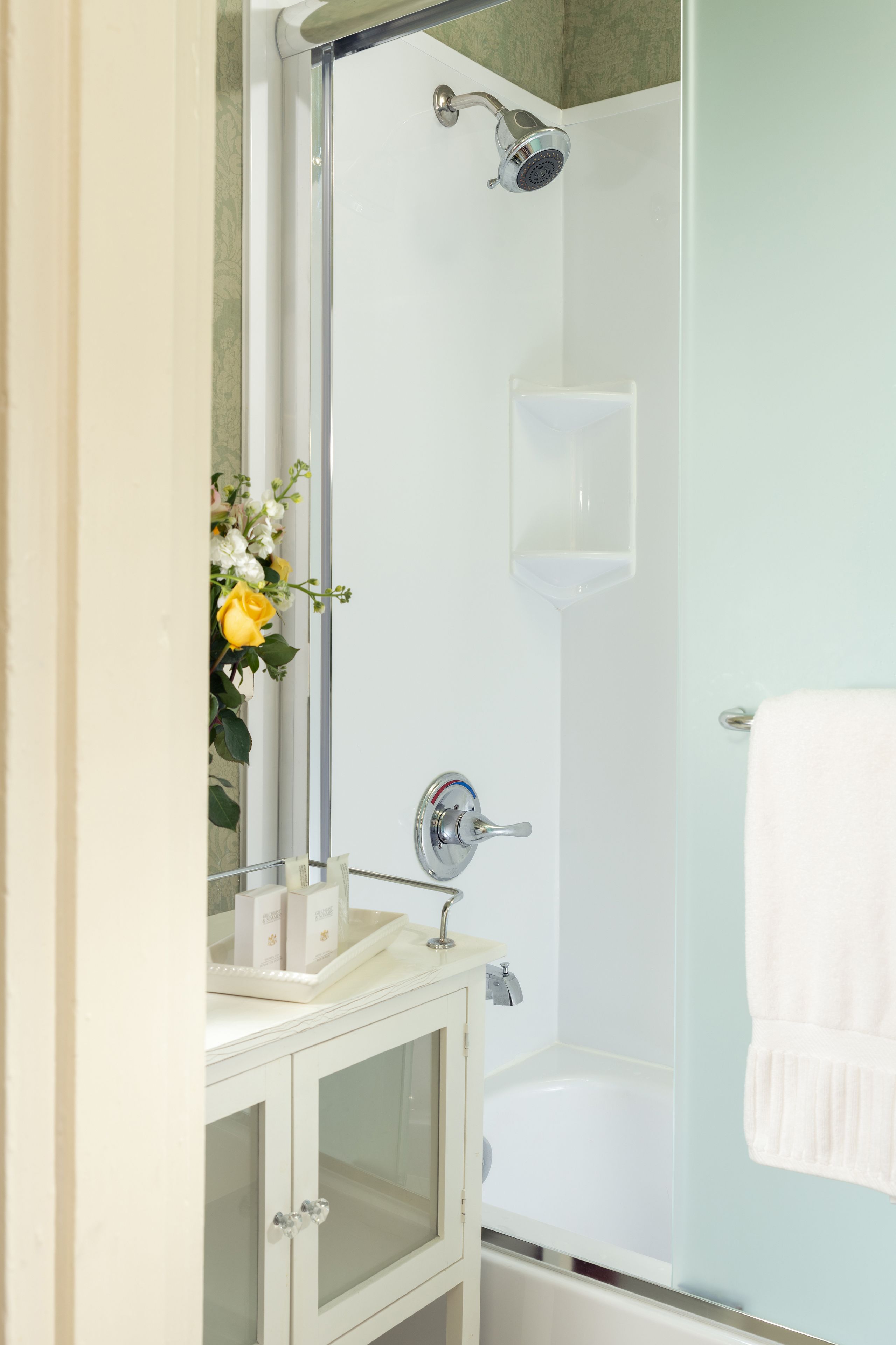 A bathroom with a shower, a sink, and a bathtub.