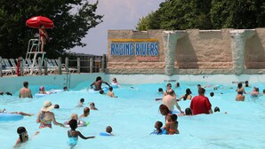 A water park with a sign reading "Raging Rivers Water Park".