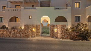 A building with a central entrance, stone walls, and multiple balconies. - Mitos Suites (Naxos)