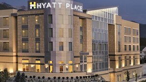 A modern Hyatt Place hotel with a prominent sign, multiple floors, and a stone facade. - Hyatt Place Salt Lake City/Cottonwood (Salt Lake City)