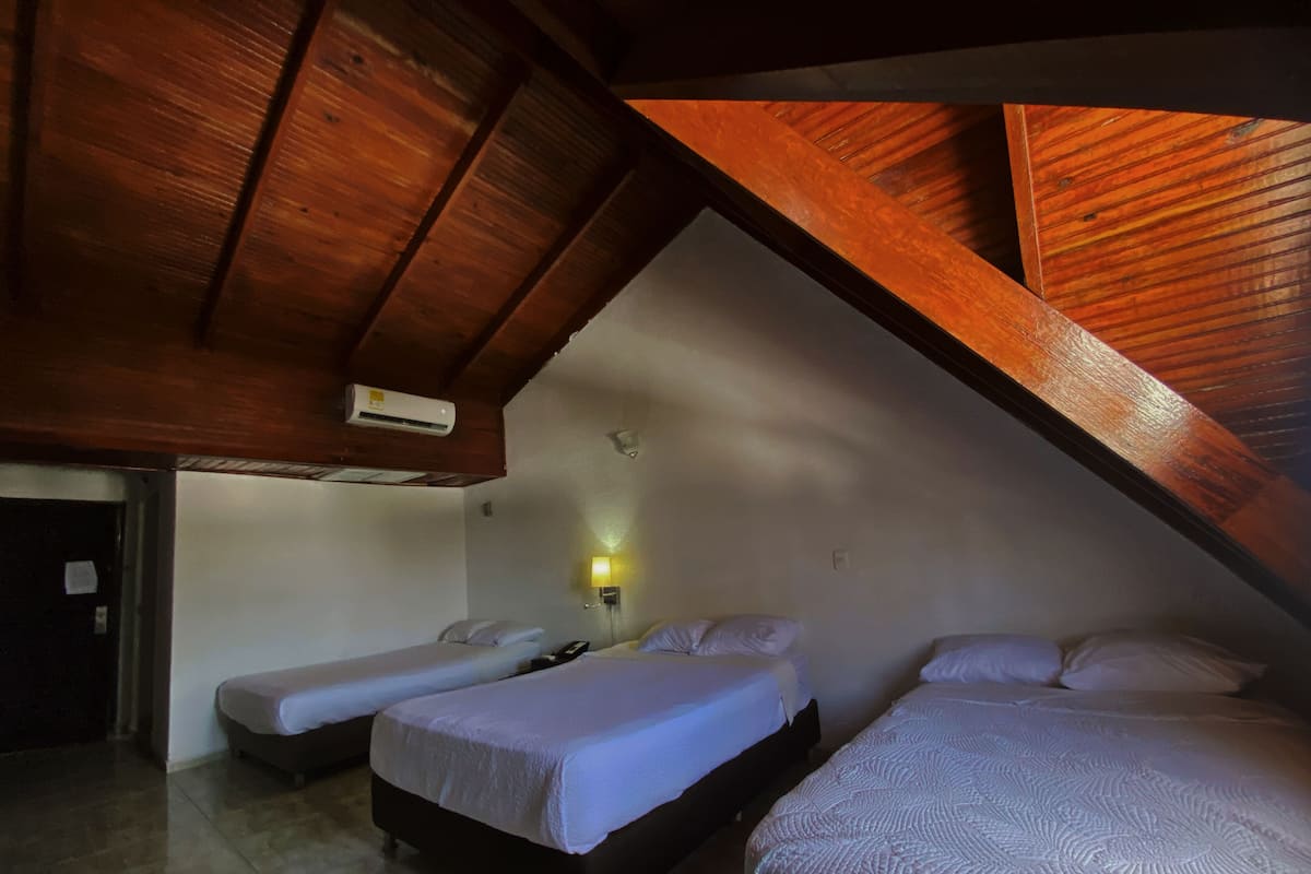 Standard Quadruple Room, Multiple Beds, Housekeeping, Partial Sea View | Minibar, in-room safe, desk, soundproofing